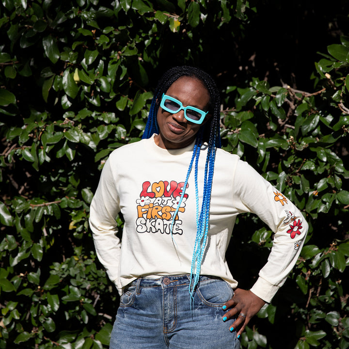 Marcelle wears the cream RollerFit Love at First Skate long sleeve t-shirt with denim jeans.