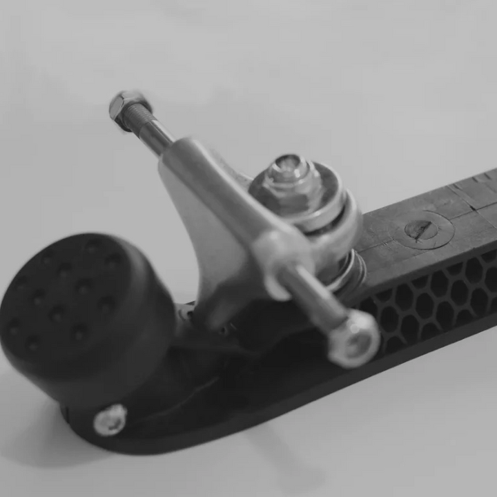 Close up of a Magic Skate Goods 2.5 Inch Low Rider wide roller skate truck on a Hex plate.