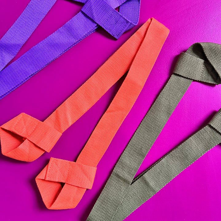 3 RollerFit Roller Skate Leashes place diagonally on a fuchsia background.