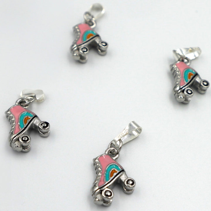 4 RollerFit Roller Skate Pendant Charms in silver arranged on a white surface