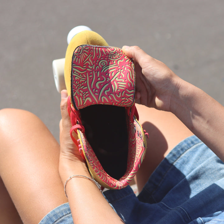 Chuffed Skates Birak roller skates with coral pink and yellow Indigenous print lining.