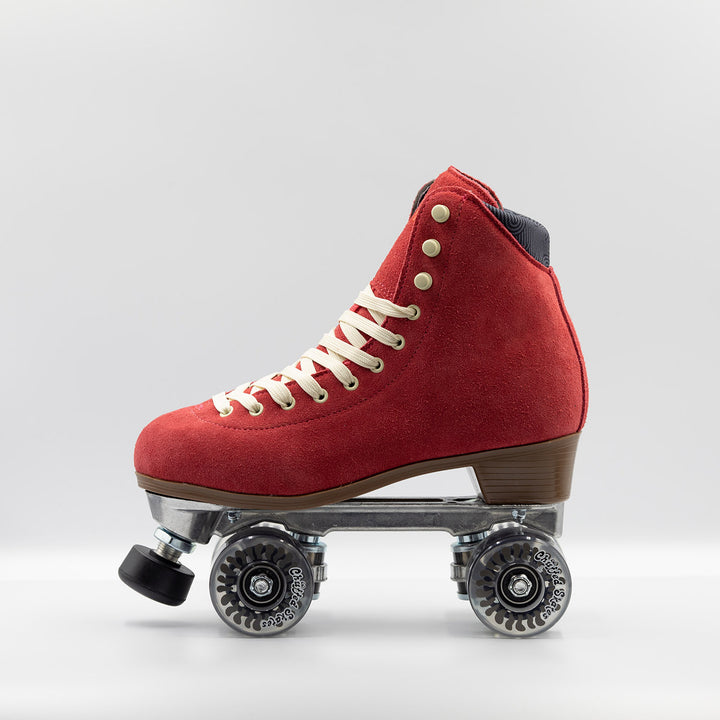 Chuffed Skates Wanderer roller skates in watermelon red with cream laces and eyelets, black toe stop, and clear wheels.