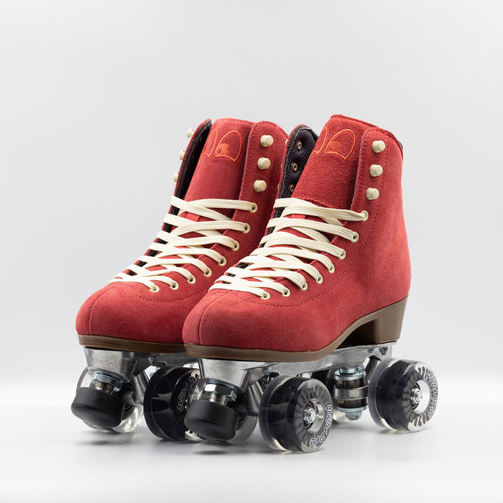 Chuffed Skates Wanderer roller skates in watermelon red with cream laces and eyelets, black toe stop, and clear wheels.