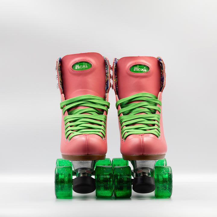 Moxi Roller Skates Beach Bunny skates in Watermelon pink with bright green laces and wheels.