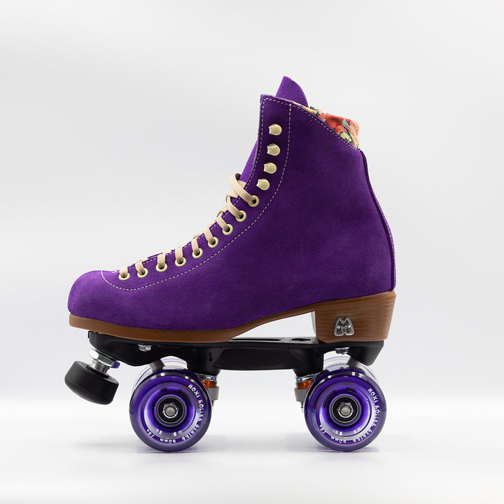 Moxi Roller Skates Lolly roller skates in Taffy purple with oyster laces and eyelets, tan sole, black plate and toe stop, matching purple wheels.