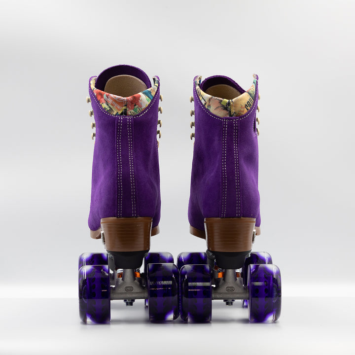 Moxi Roller Skates Lolly roller skates in Taffy purple with oyster laces and eyelets, tan sole, black plate and toe stop, matching purple wheels.