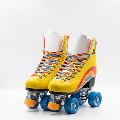 Moxi Roller Skates Rainbow Rider in Sunshine Yellow with white tongue, blue wheels and orange toe stop.