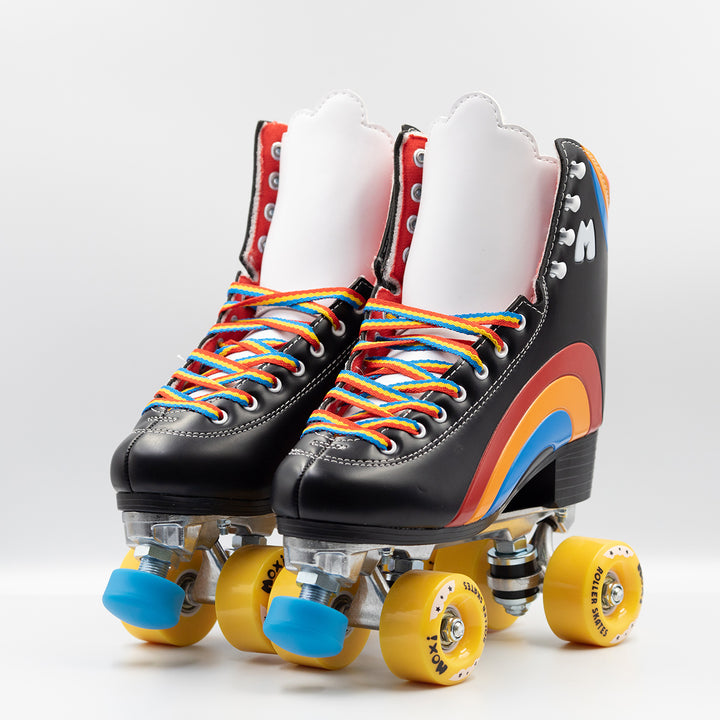 Moxi Roller Skates Rainbow Riders in Asphalt Black with white tongue, yellow wheels and blue toe stops.