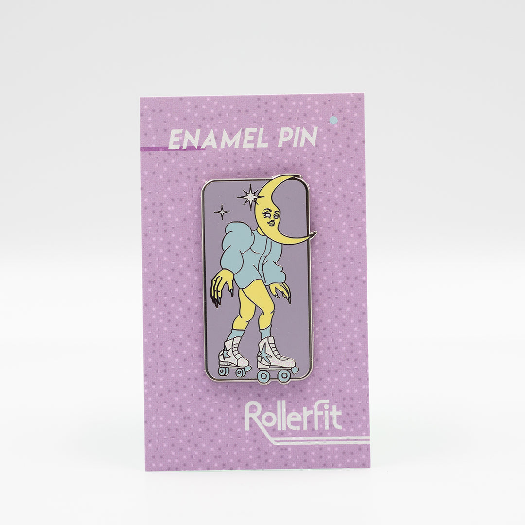 RollerFit Celestial Skater enamel pin with pastel lavender background, blue and yellow character and white glitter stars and roller skates.