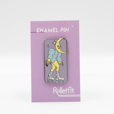 RollerFit Celestial Skater enamel pin with pastel lavender background, blue and yellow character and white glitter stars and roller skates.