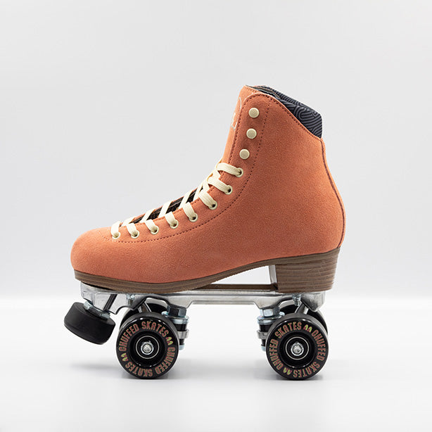 Chuffed Skates Wanderer Roller Skates in Peach Pink with cream laces and embroidered Chuffed eye logo on tongue, black wheels and toe stop.