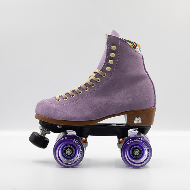 Moxi Roller Skates Lolly roller skates in Lilac with oyster laces and eyelets, tan sole, black plate and toe stop, matching purple wheels.
