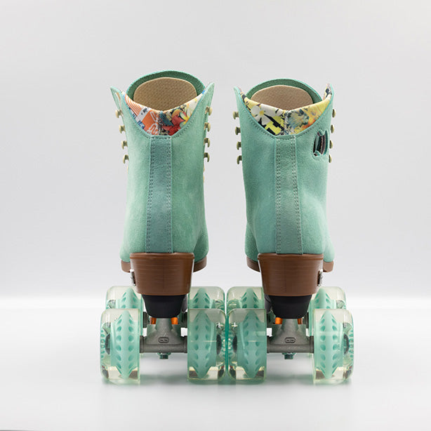 Moxi Roller Skates Lolly roller skates in Floss teal with oyster laces and eyelets, tan sole, black plate and toe stop, matching teal wheels.