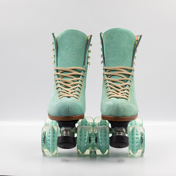 Moxi Roller Skates Lolly roller skates in Floss teal with oyster laces and eyelets, tan sole, black plate and toe stop, matching teal wheels.