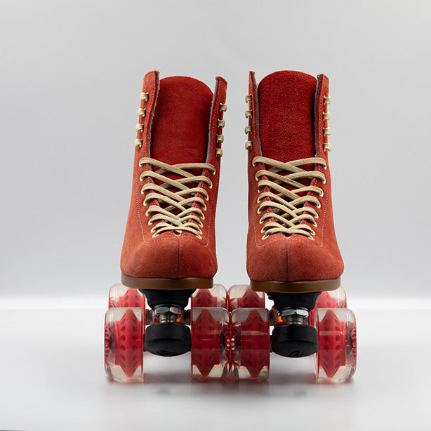 Moxi Roller Skates Lolly roller skates in Poppy red with oyster laces and eyelets, tan sole, black plate and toe stop, matching red wheels.