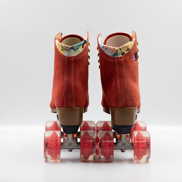 Moxi Roller Skates Lolly roller skates in Poppy red with oyster laces and eyelets, tan sole, black plate and toe stop, matching red wheels.