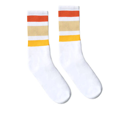 Socco white tube sock with 3 stripes above the ankle in yellow, cream and burnt orange.
