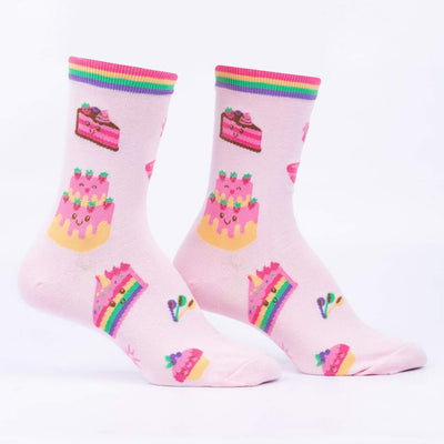 Pastel pink socks with cartoon cakes with smiley faces. 