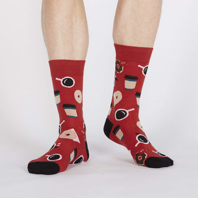 Rust red sock with coffee mugs and takeaway cups and donuts.
