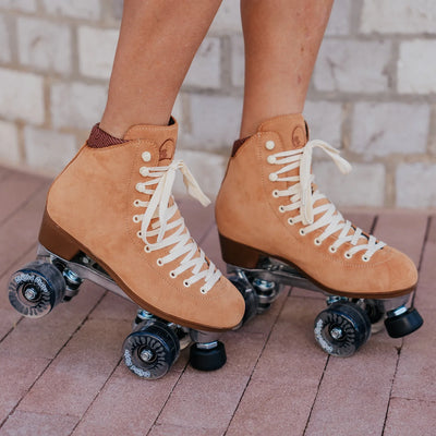 Chuffed Skates Wanderer roller skates in Caramel with cream laces and eyelets, black toe stop, and clear wheels.