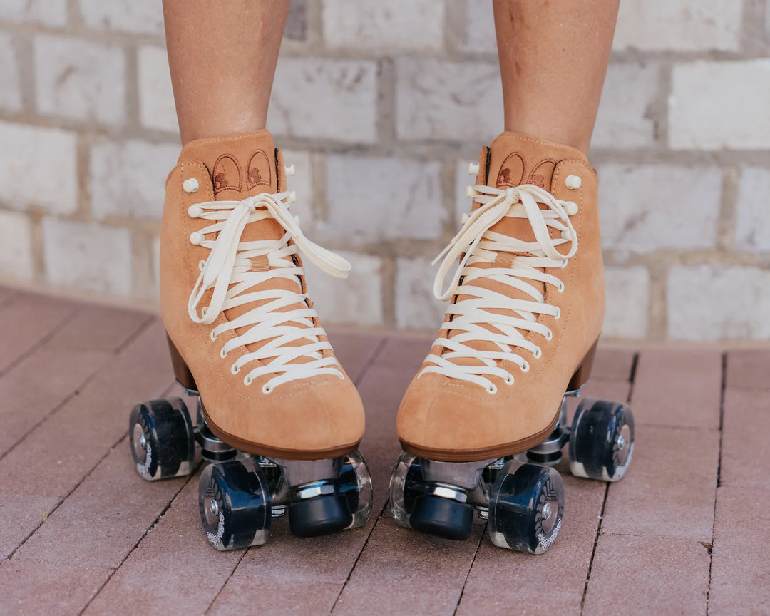 Chuffed Skates Wanderer roller skates in Caramel with cream laces and eyelets, black toe stop, and clear wheels.