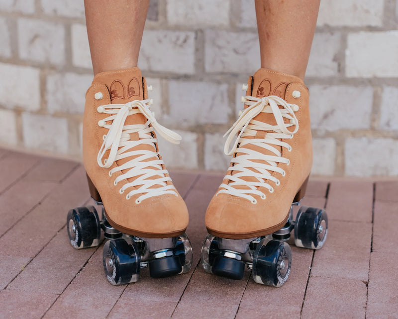 Chuffed Skates Wanderer roller skates in Caramel with cream laces and eyelets, black toe stop, and clear wheels.