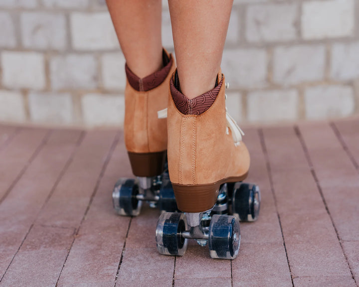 Chuffed Skates Wanderer roller skates in Caramel with cream laces and eyelets, black toe stop, and clear wheels.