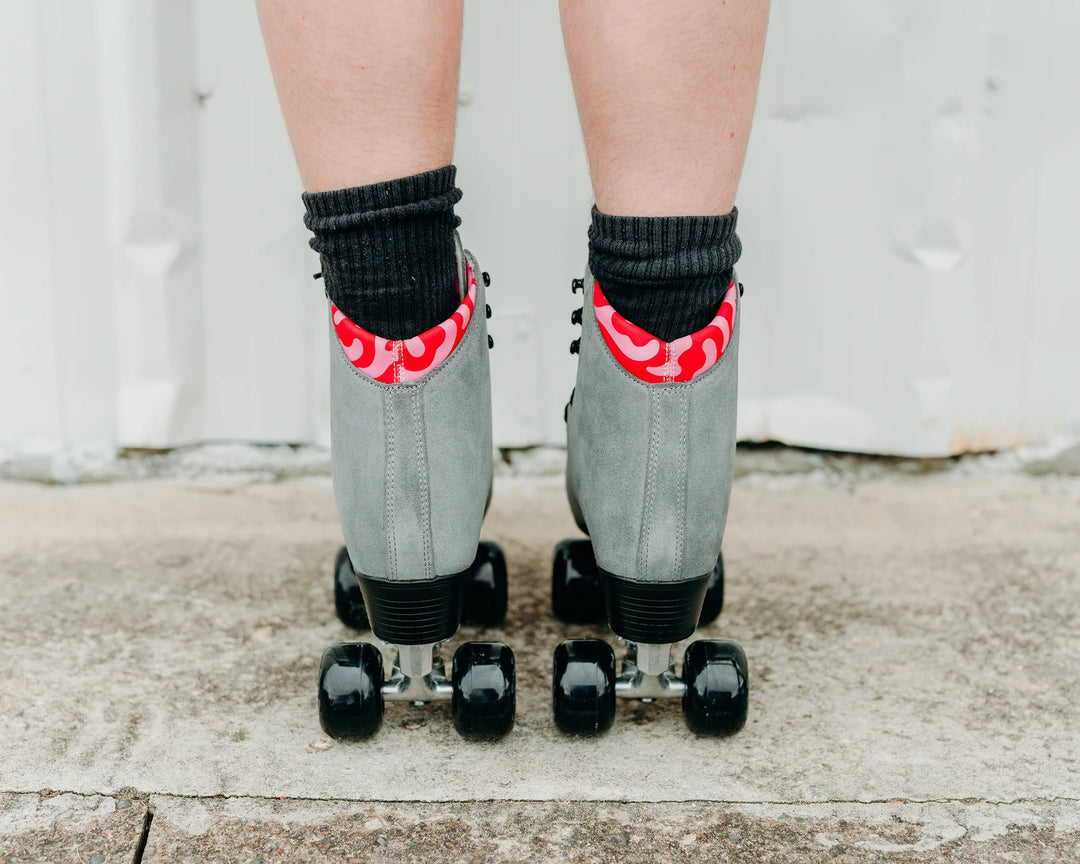 Chuffed Skates Wanderer Plus in Concrete grey with pink and red swirl lining, black wheels and toe stop.