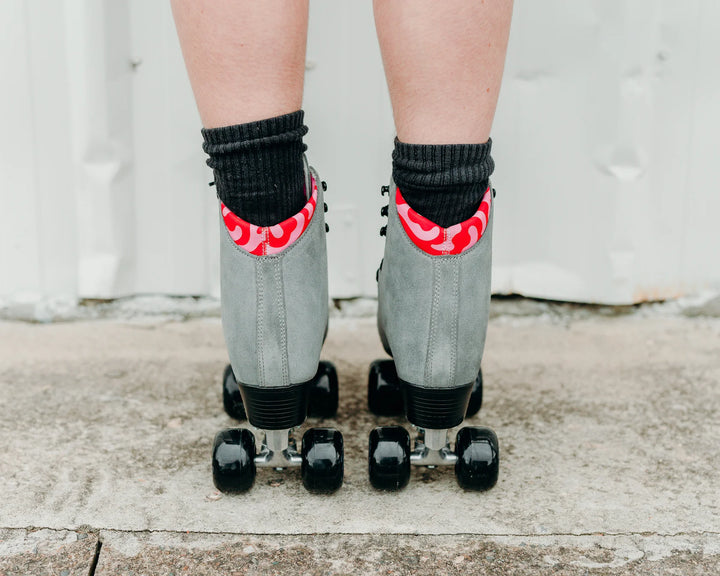 Chuffed Skates Wanderer Plus in Concrete grey with pink and red swirl lining, black wheels and toe stop.