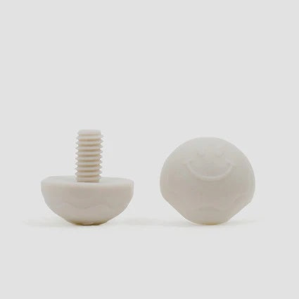 A pair of cream bolt-on toe plugs for roller skates, displayed on a plain background.