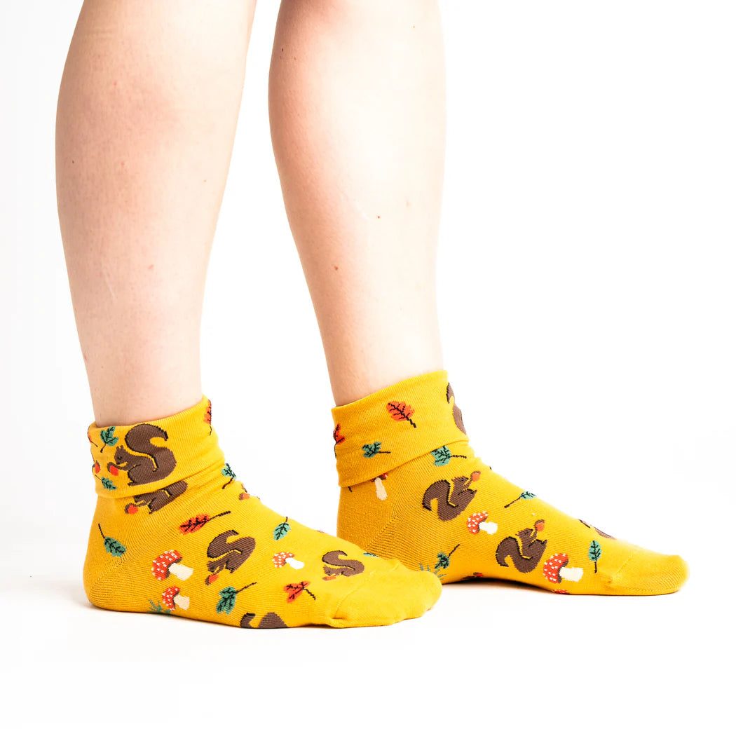 sock it to me turn cuff crew socks in mustard yellow with squirrels, autumnal leaves and toadstools