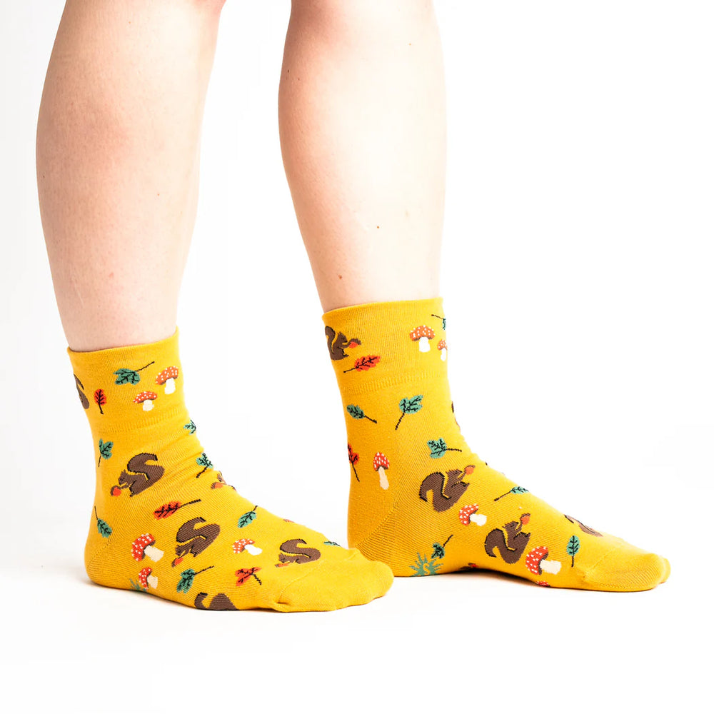 sock it to me turn cuff crew socks in mustard yellow with squirrels, autumnal leaves and toadstools