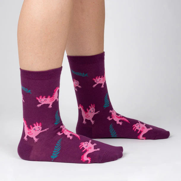 Burgundy coloured sock s with pink cartoon axolotls and green ferns