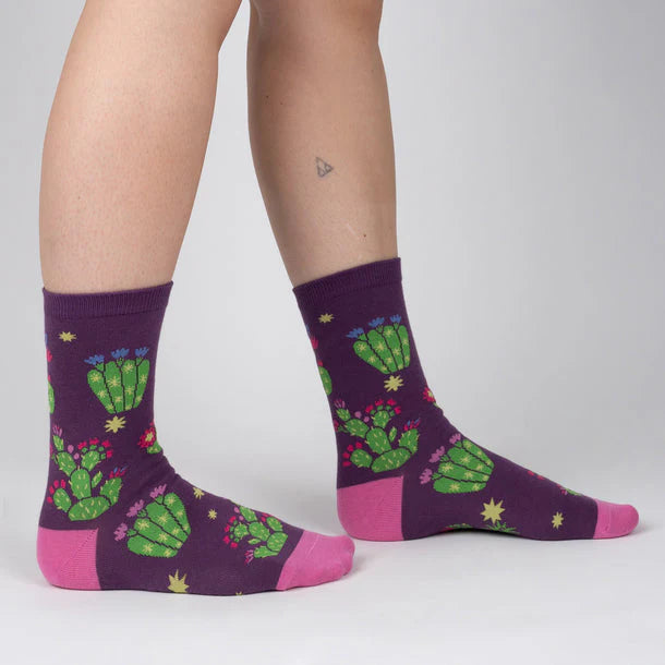 Dark purple crew socks with bright green succulents with purple, red, pink and blue flowers.