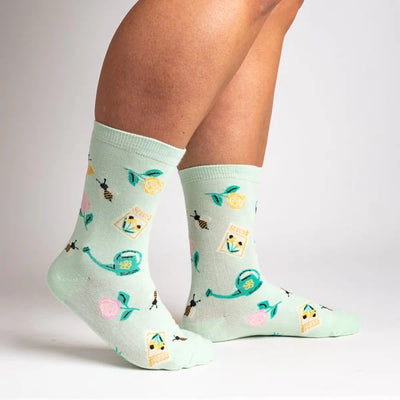 Sock it to Me Womens crew socks - Sow in Love - pastel mint with yellow flowers, bees, watering can, seed packets and pink flowers.