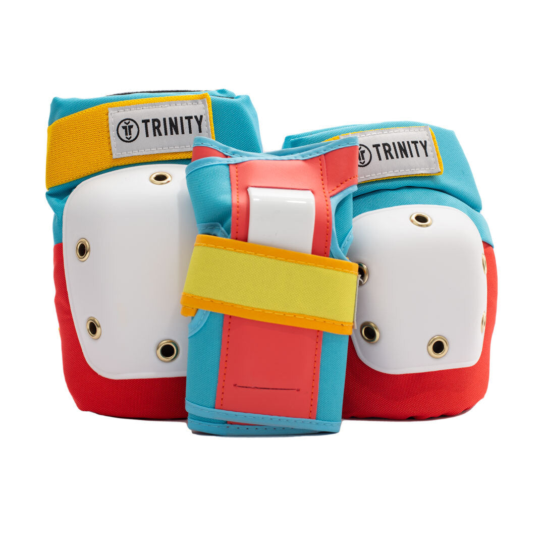 Trinity Pad pack with knee pads, elbow pads and wrists guards in retro primary colours (red, blue and yellow) with white caps.