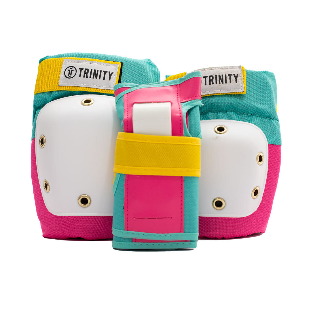 Trinity Pad pack with knee pads, elbow pads and wrists guards in pink and teal with yellow straps and white caps.