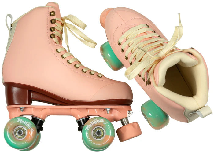 Pair of Dusty Pink Chaya Melrose Elite roller skates with mint green wheels on a white background
