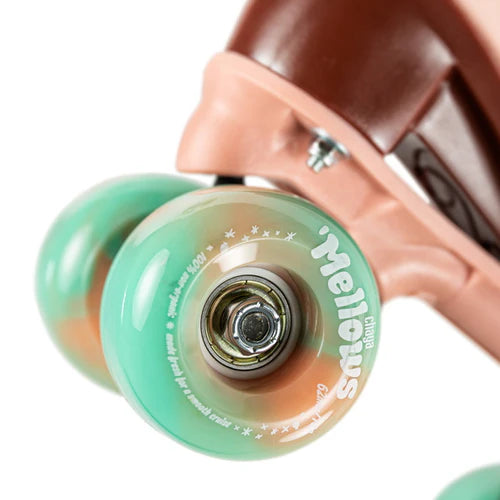 Close up of Dusty Pink Chaya Melrose Elite roller skate with mint green wheels on a white background
