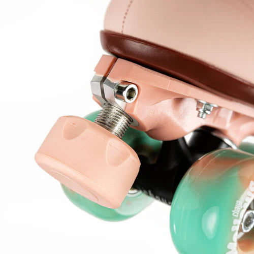 Close up of Dusty Pink Chaya Melrose Elite roller skate with mint green wheels on a white background