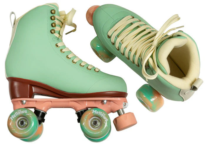 Pair of Mint green Chaya Melrose Elite roller skates with mint green wheels and dusty pink plate and toe stop on a white background