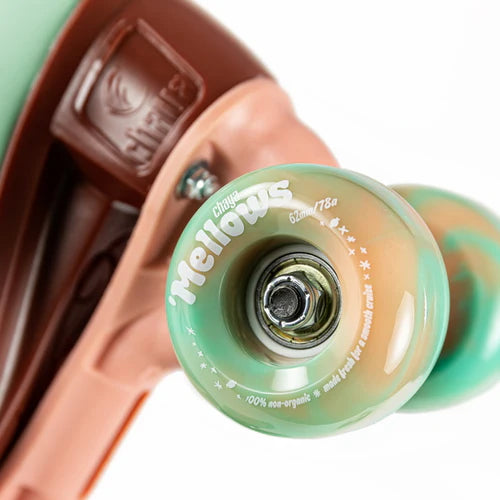 Close up of Mint green Chaya Melrose Elite roller skate with mint green wheels and dusty pink plate and toe stop on a white background