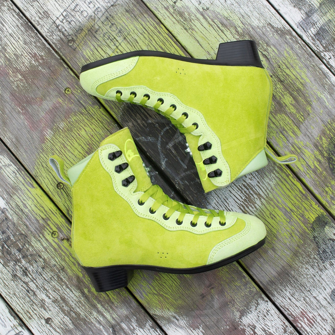 Pair of bright lime green Rib Pro Boots from Chuffed Skates on a wooden surface