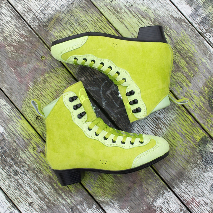 Pair of bright lime green Rib Pro Boots from Chuffed Skates on a wooden surface