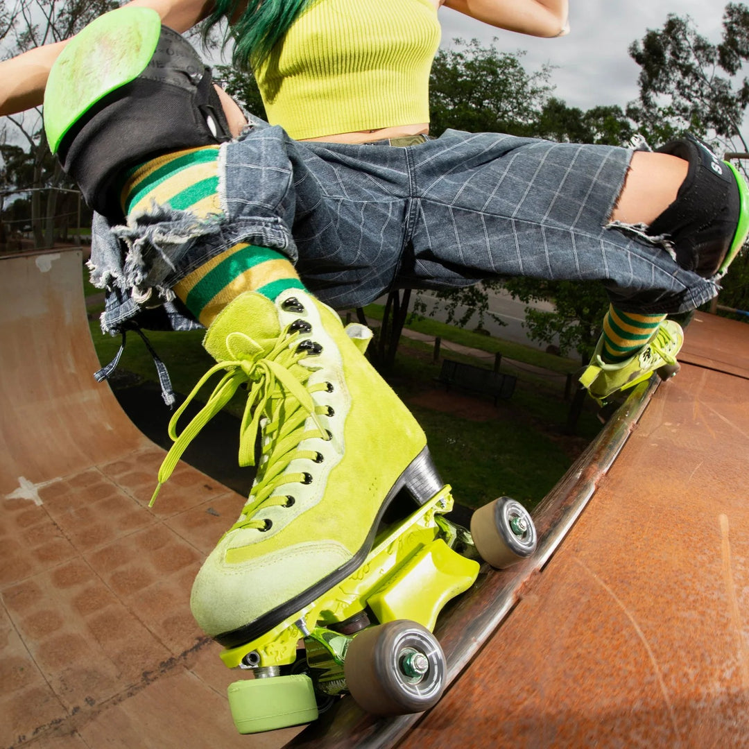Rib doing a big grind on a vert ramp at a skatepark wearing her new Rib Pro Boots from Chuffed Skates