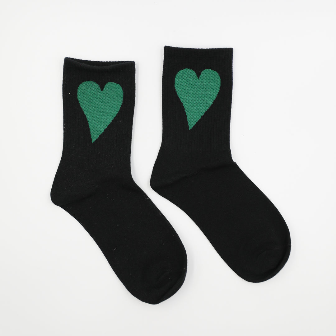 Black socks with green hearts on a white background