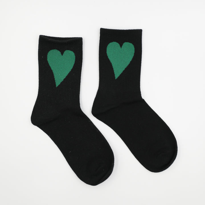 Black socks with green hearts on a white background