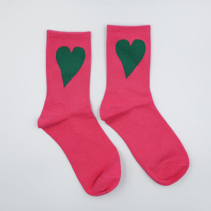 Pink socks with green hearts on a white background