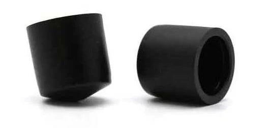 Two black cylindrical rubber pivot cups on a white background