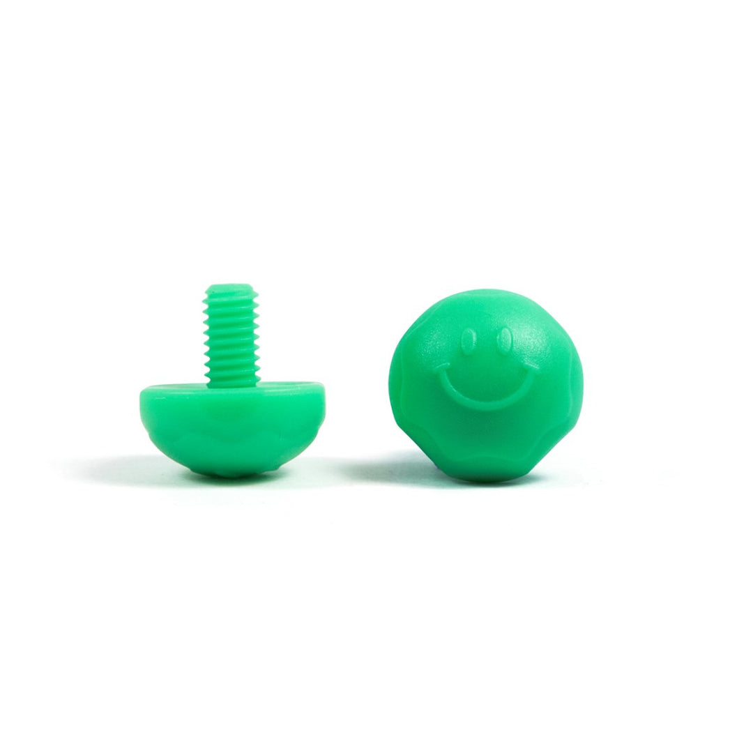 A pair of green bolt-on toe plugs for roller skates, displayed on a plain background.